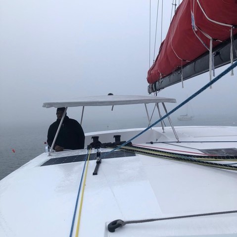 Cpt. Karl Reed looks out from the cockpit. The sea is misty and Karl is wrapped up in a fleece and hat